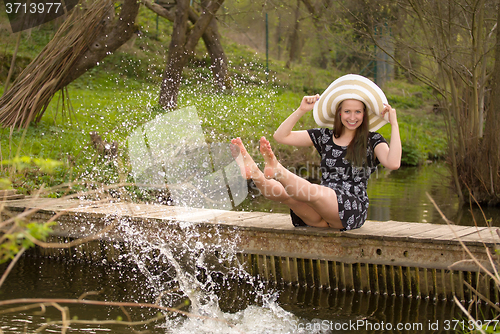 Image of Cheerful fashionable woman on small bridge