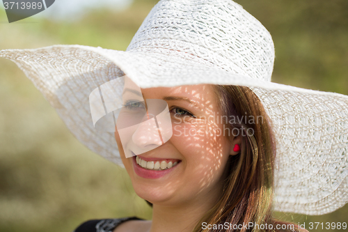 Image of cheerful fashionable woman with hat