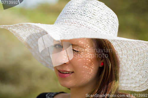 Image of cheerful fashionable woman with hat