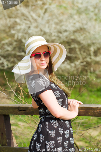 Image of cheerful fashionable woman with hat