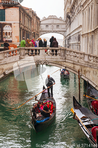 Image of Gondola with tourists in Venice, Italy