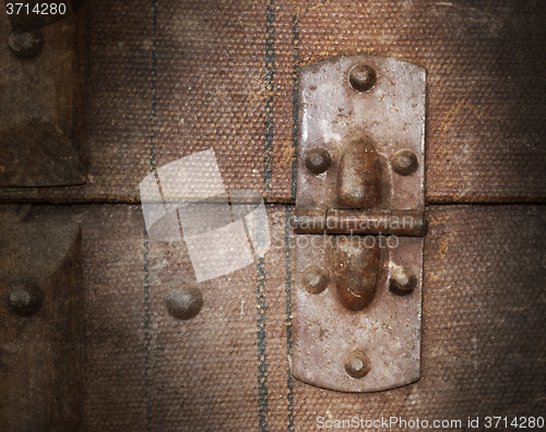 Image of Old canvas trunk hinge close up