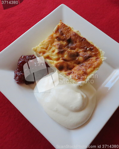 Image of Cheese cake with jam and cream