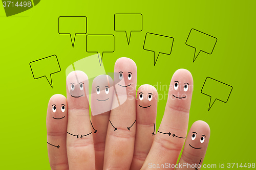 Image of Happy finger smileys with speech bubbles on green background