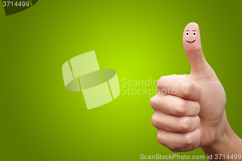 Image of Happy cheerful smiley finger on green background