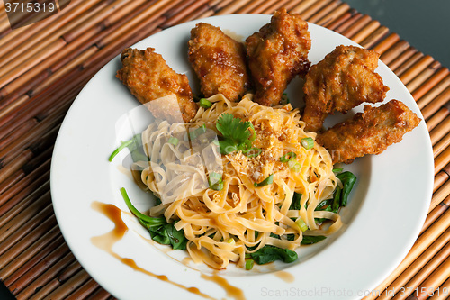 Image of Chicken Wings with Noodles and Spinach