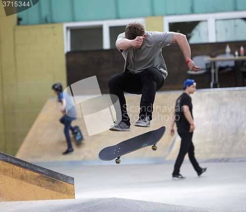 Image of Male skater jumping high in the air