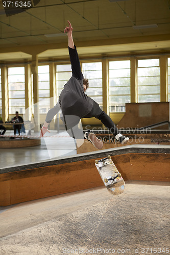 Image of Male skater jumping high in the air