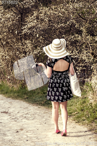Image of Back view of cheerful fashionable woman