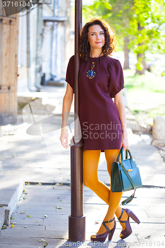 Image of smiling middle-aged woman in a burgundy dress