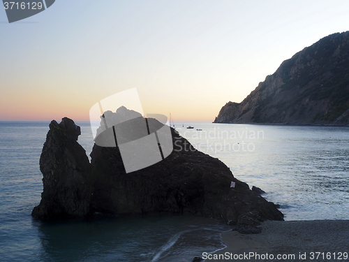 Image of rock small island outcropping  beach Monterosso Italy resort Eur