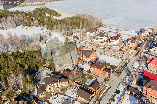 Image of Aerial view on suburban street near lake at spring