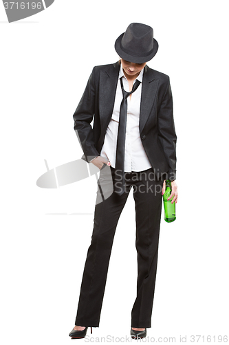 Image of businesswoman wearing a hat and tie, holding bottle of alcohol. Isolated on white background