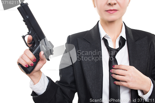 Image of beautiful girl gangster holding a gun. Classic suit and hat. isolated on white 