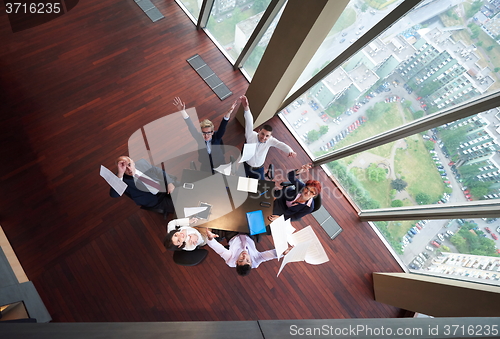 Image of top view of business people group throwing dociments in air