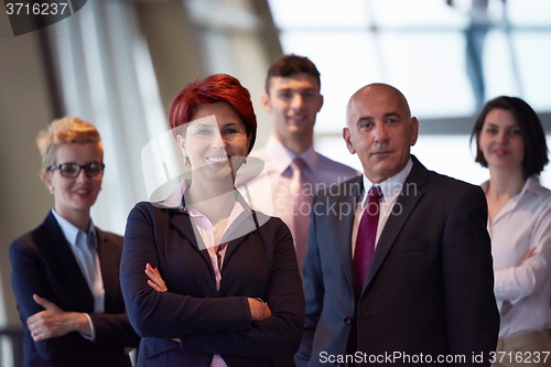 Image of diverse business people group with redhair  woman in front