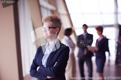 Image of business people group, woman in front  as team leader