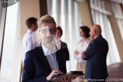 Image of diverse business people group with blonde  woman in front