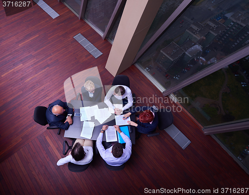 Image of top view of business people group throwing dociments in air