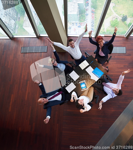 Image of top view of business people group throwing dociments in air