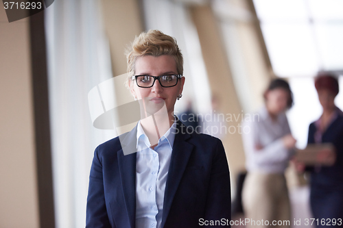 Image of business people group, woman in front  as team leader