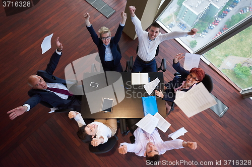 Image of top view of business people group throwing dociments in air