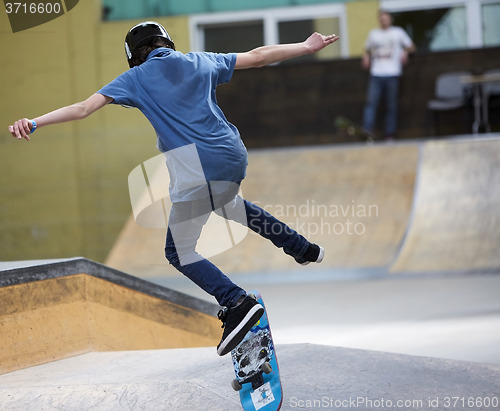 Image of Male skater jumping high in the air