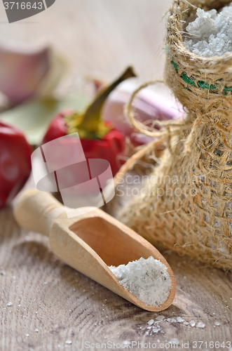 Image of Salt spoon on wooden background