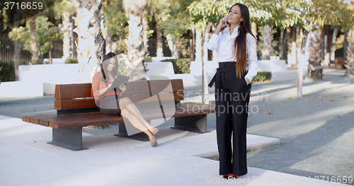 Image of Chic young woman chatting on her mobile