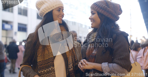 Image of Two women chatting at a street in winter