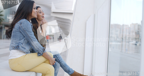 Image of Two trendy young women relaxing