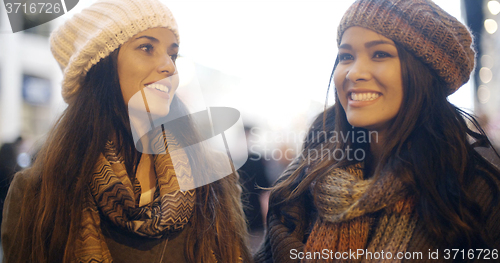 Image of Two young woman enjoying a winter night out