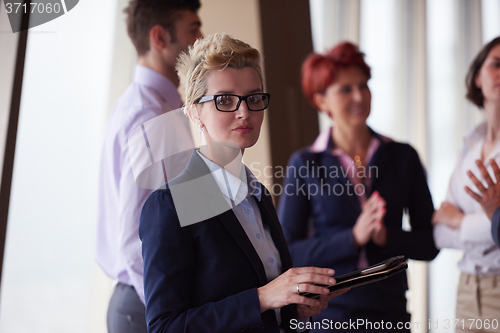 Image of diverse business people group with blonde  woman in front