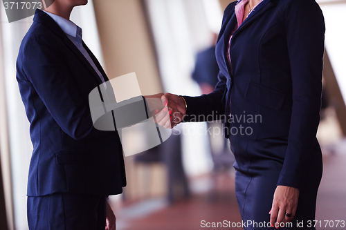 Image of business womans make deal and handshake