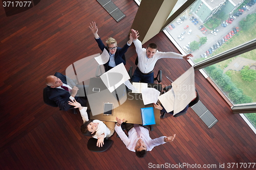 Image of top view of business people group throwing dociments in air