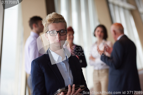 Image of diverse business people group with blonde  woman in front