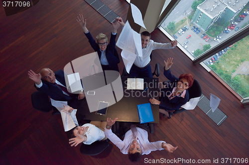 Image of top view of business people group throwing dociments in air