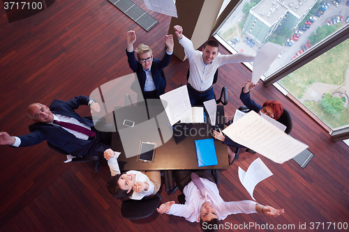 Image of top view of business people group throwing dociments in air