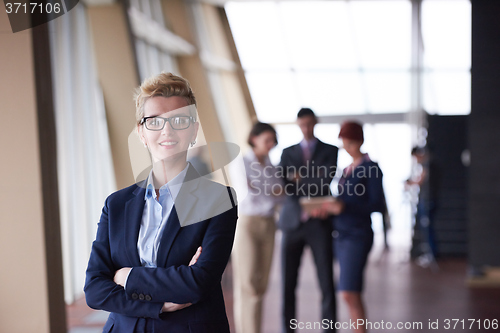 Image of business people group, woman in front  as team leader