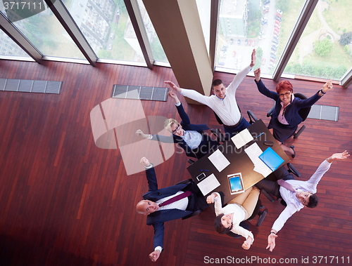 Image of top view of business people group throwing dociments in air