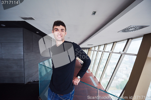 Image of young successful man in penthouse apartment