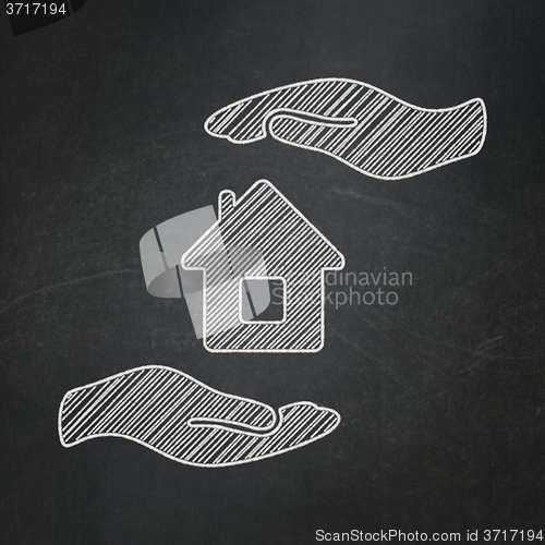 Image of Insurance concept: House And Palm on chalkboard background