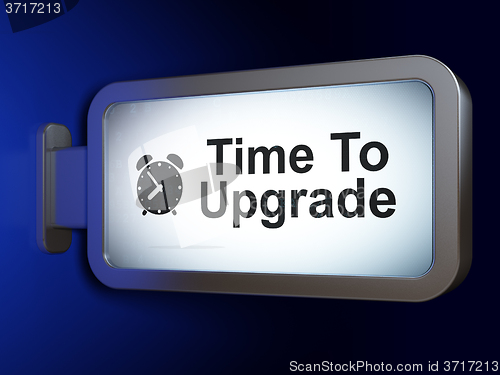 Image of Time concept: Time To Upgrade and Alarm Clock on billboard background