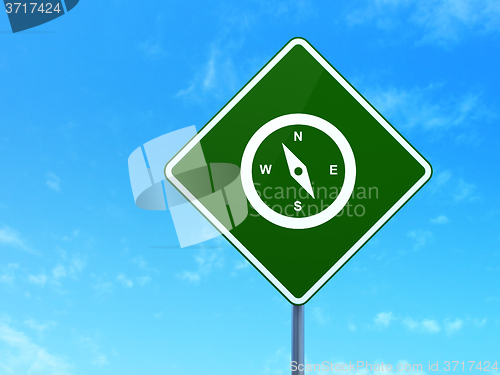 Image of Travel concept: Compass on road sign background