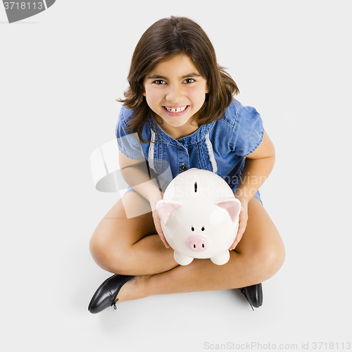 Image of Young girl holding a piggybank