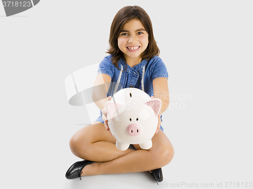 Image of Young girl holding a piggybank