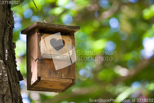 Image of Bird house with the heart shapped entrance.