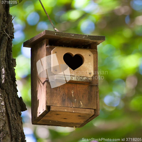 Image of Bird house with the heart shapped entrance.