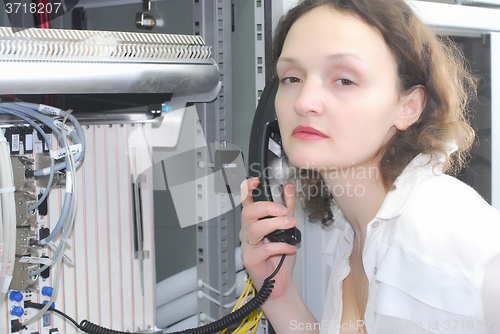 Image of Woman working on telecommunication equipment