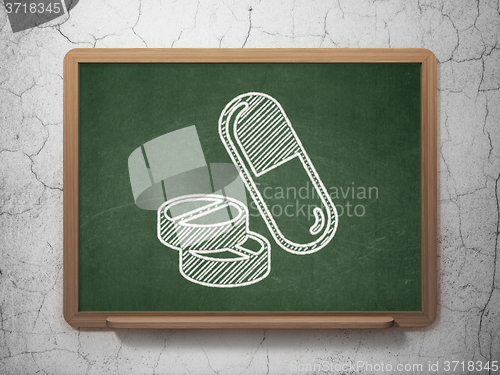 Image of Medicine concept: Pills on chalkboard background